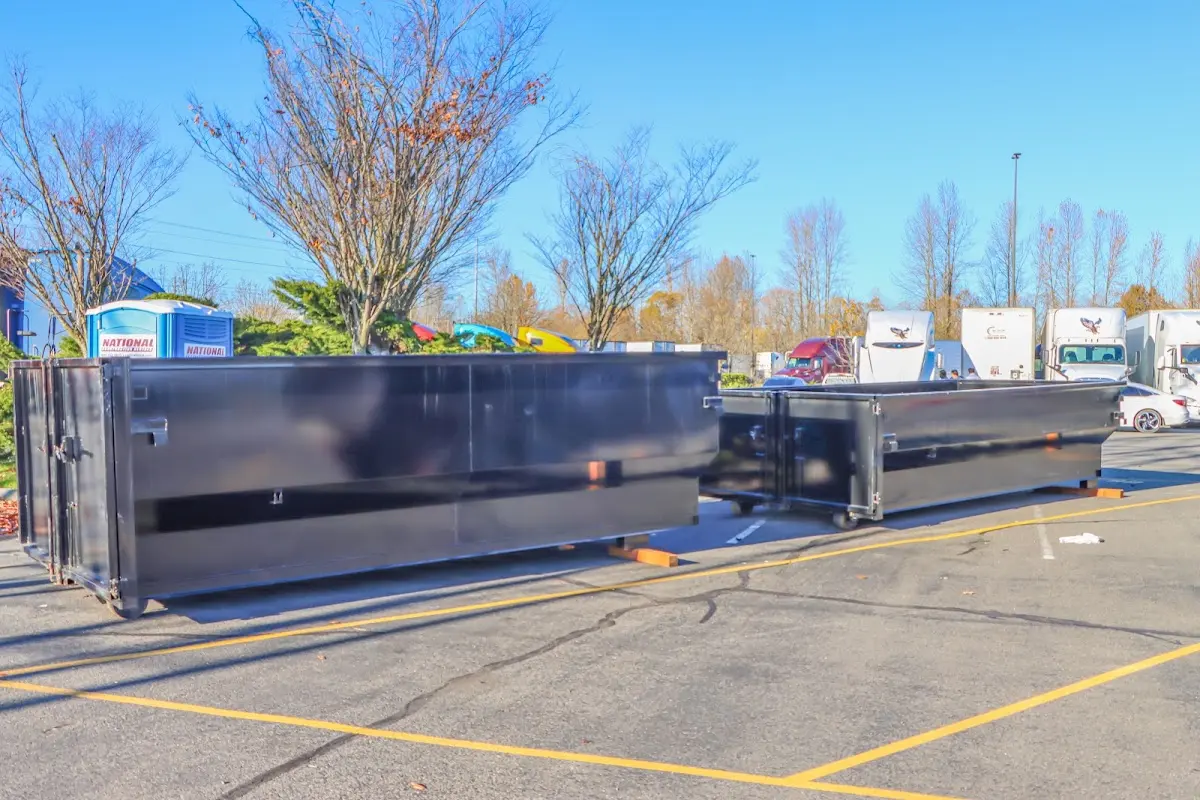 Professional dumpster rental service with roll-off container on residential driveway in Exeter